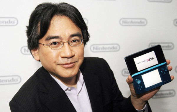 Satoru Iwata with a Nintendo DS